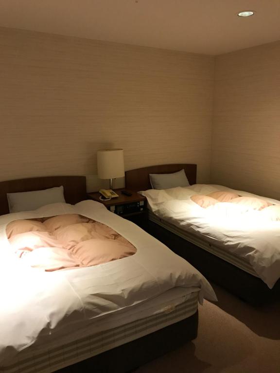 Postel nebo postele na pokoji v ubytování Hotel Higashidate