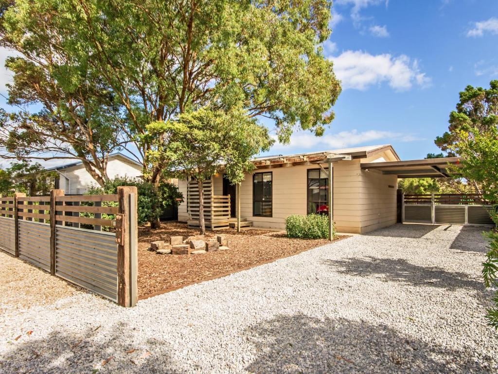 a house with a fence in front of it at Sea Devine - Port Willunga - C21 SouthCoast Holidays in Port Willunga