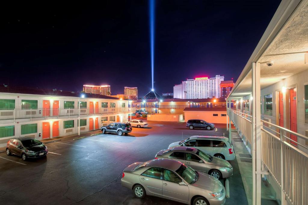 a parking lot with cars parked in front of buildings at Motel 6-Las Vegas, NV - Tropicana in Las Vegas