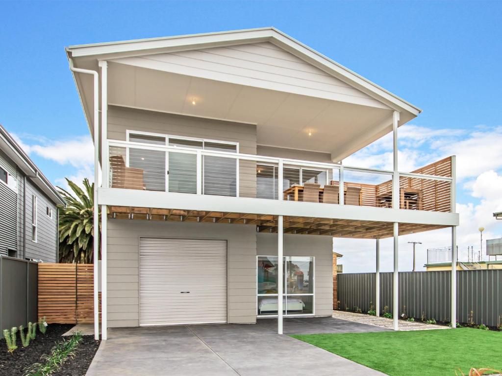 a large white house with a deck at Seas the Day - Aldinga Beach - C21 SouthCoast Holidays in Aldinga Beach