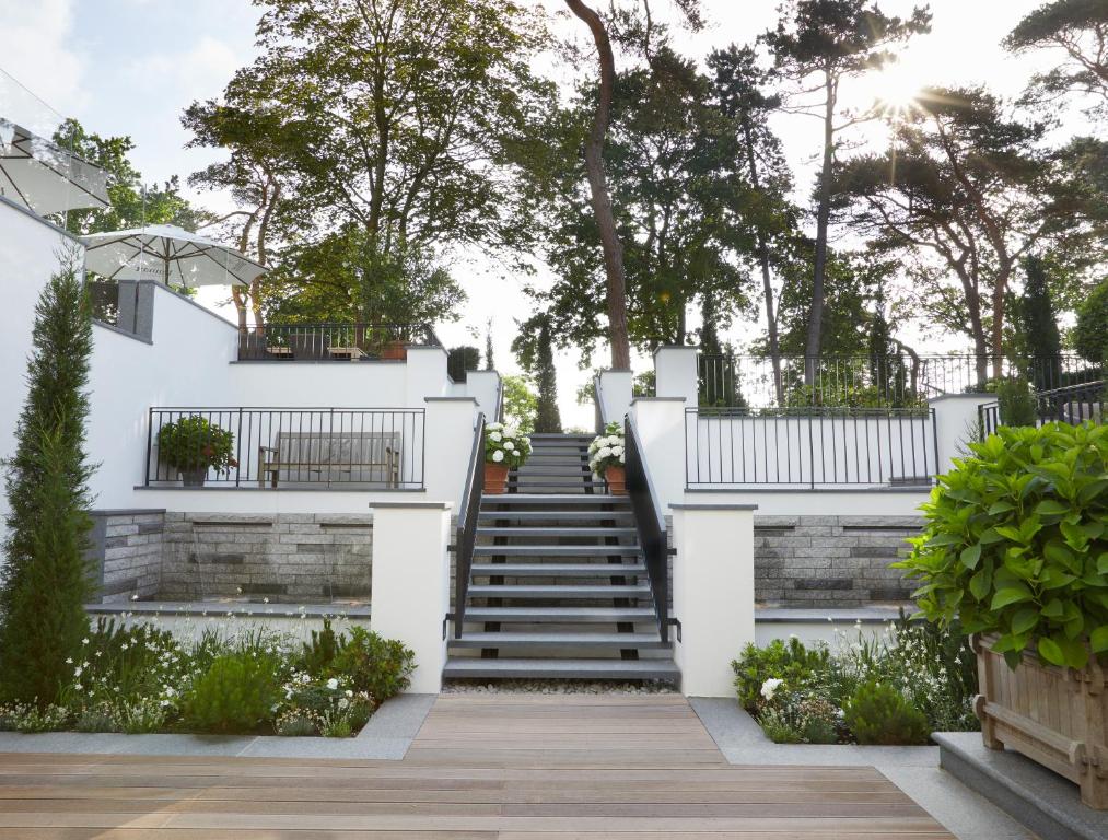 a staircase leading up to a white house at Strandhotel Fontana in Timmendorfer Strand