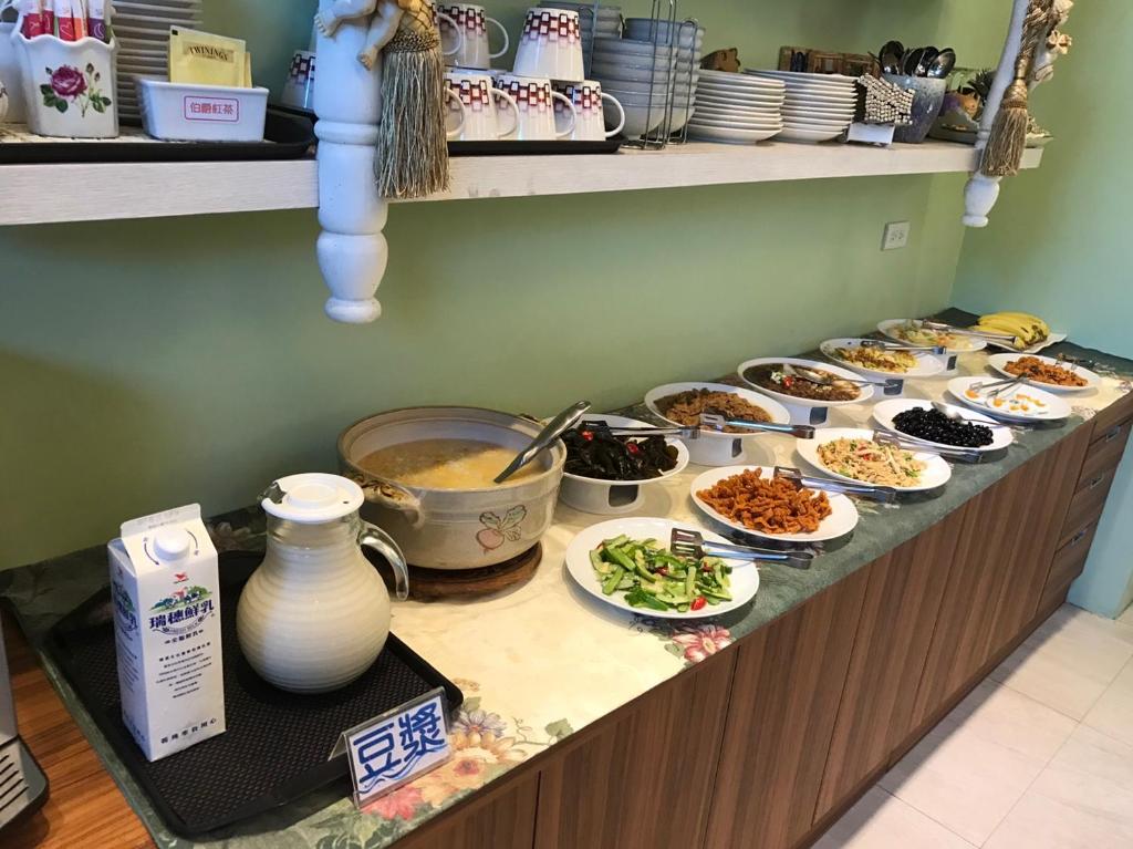 a buffet with dishes of food on a counter at Jane Castle in Wujie