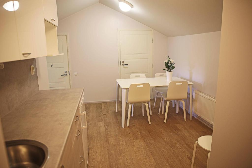 a kitchen with a white table and chairs at Savonlinnan Kansanopisto - Wanha Pappila in Savonlinna