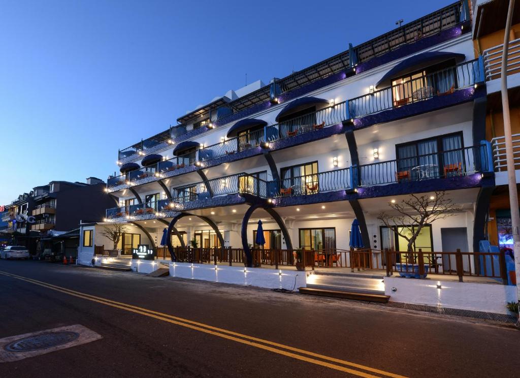 a building with balconies on the side of a street at Kenting Coast Resort in Kenting