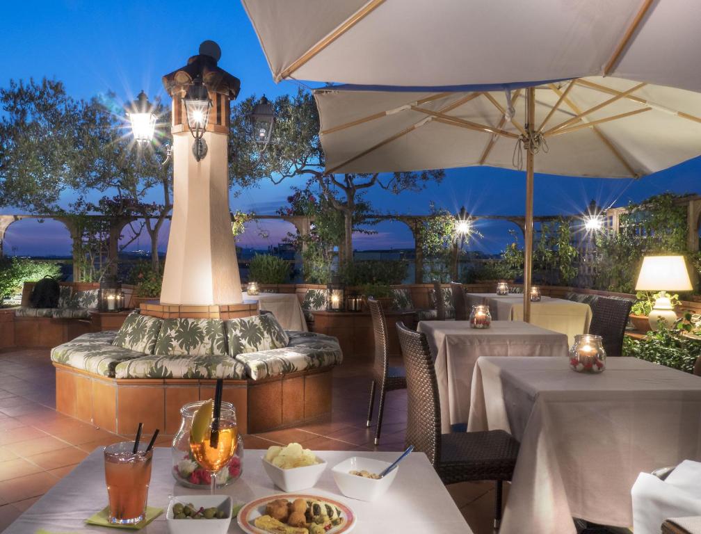 a restaurant with two tables and a lighthouse at Diana Roof Garden in Rome