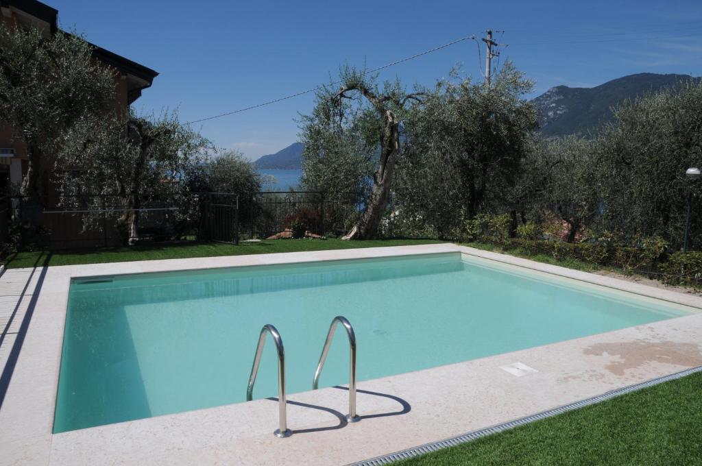 a swimming pool in the yard of a house at Holiday House Margherita in Brenzone sul Garda