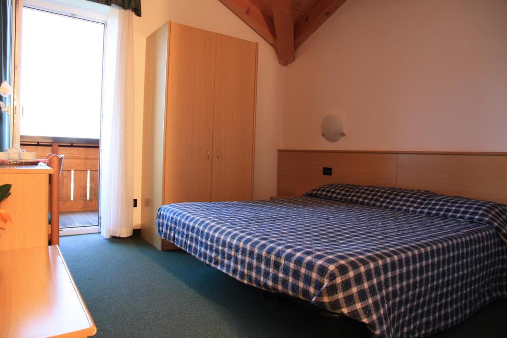 Postel nebo postele na pokoji v ubytování Albergo Miramonti