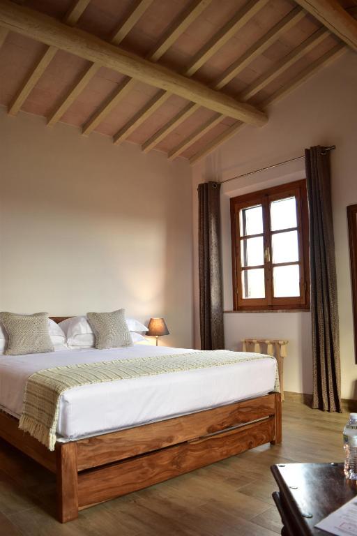 a bedroom with a bed and a window at Villa San Michele in Barberino di Val dʼElsa