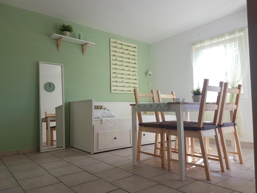 a dining room with a table and chairs at Apartments Silver in Novalja