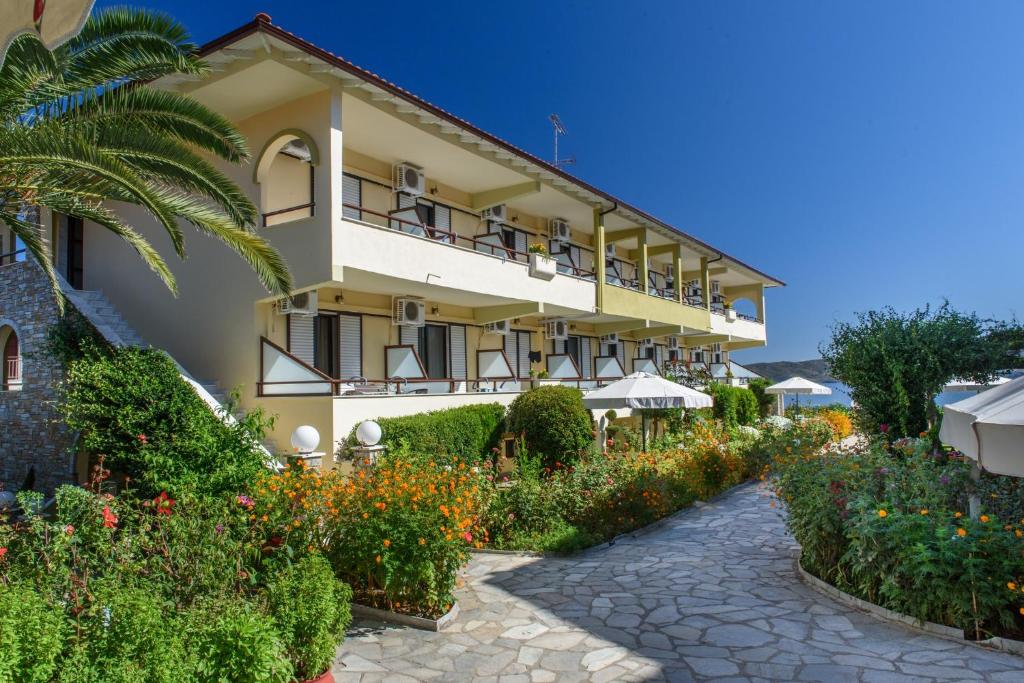 a hotel with a garden in front of it at Sun Rise Hotel in Ammouliani