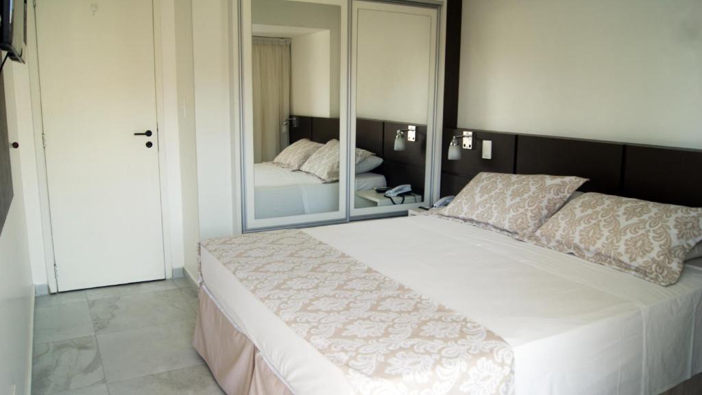 Postel nebo postele na pokoji v ubytování Littoral Tambaú Flat