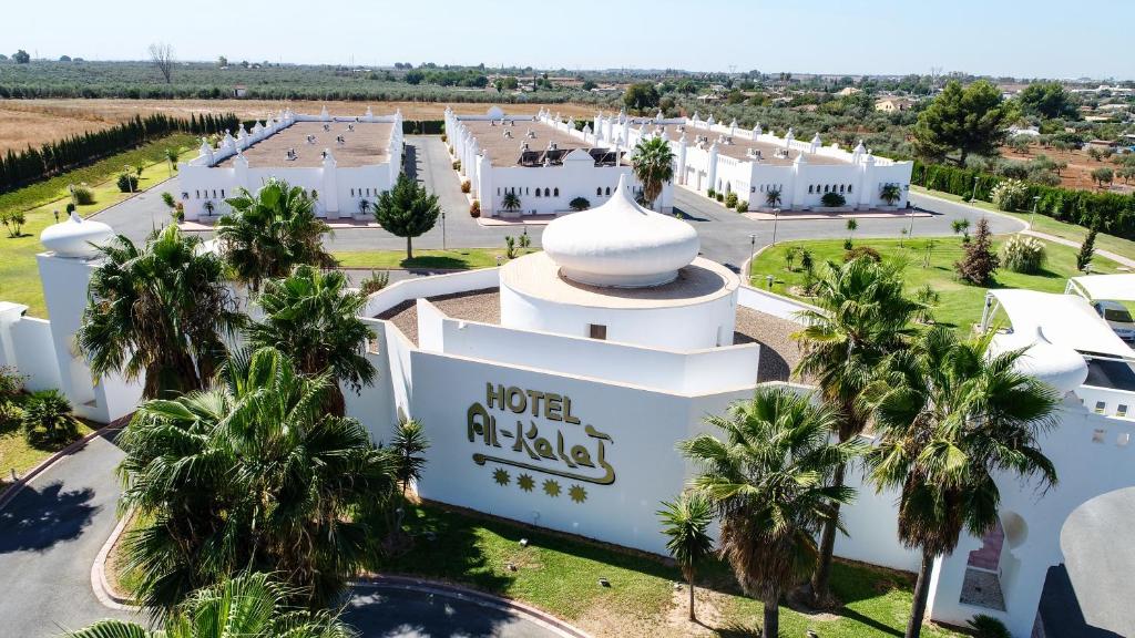 an aerial view of a hotel with palm trees at Hotel Alkalat in Alcalá de Guadaira