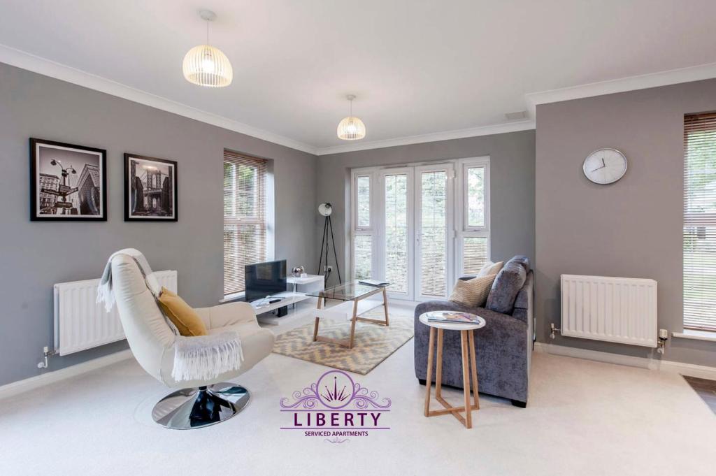 uma sala de estar com um sofá branco e uma mesa em Liberty Suite Apartment em Portishead