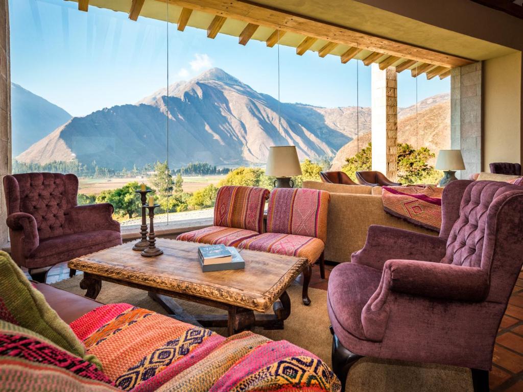 a living room with a view of a mountain at Inkaterra Hacienda Urubamba in Urubamba