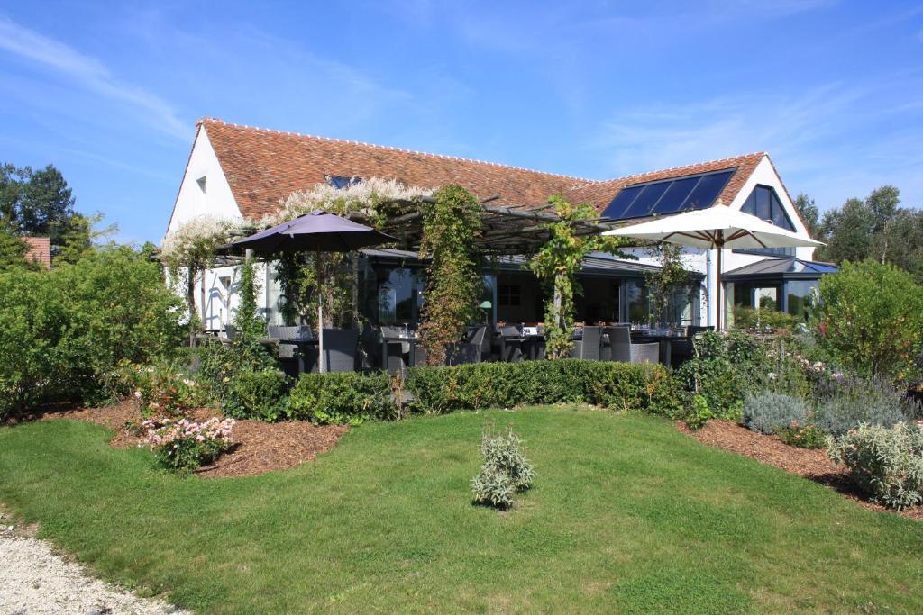 a house with a garden in front of it at Domaine de Bellevue, The Originals Relais (Relais du Silence) in Neufmoutiers-en-Brie