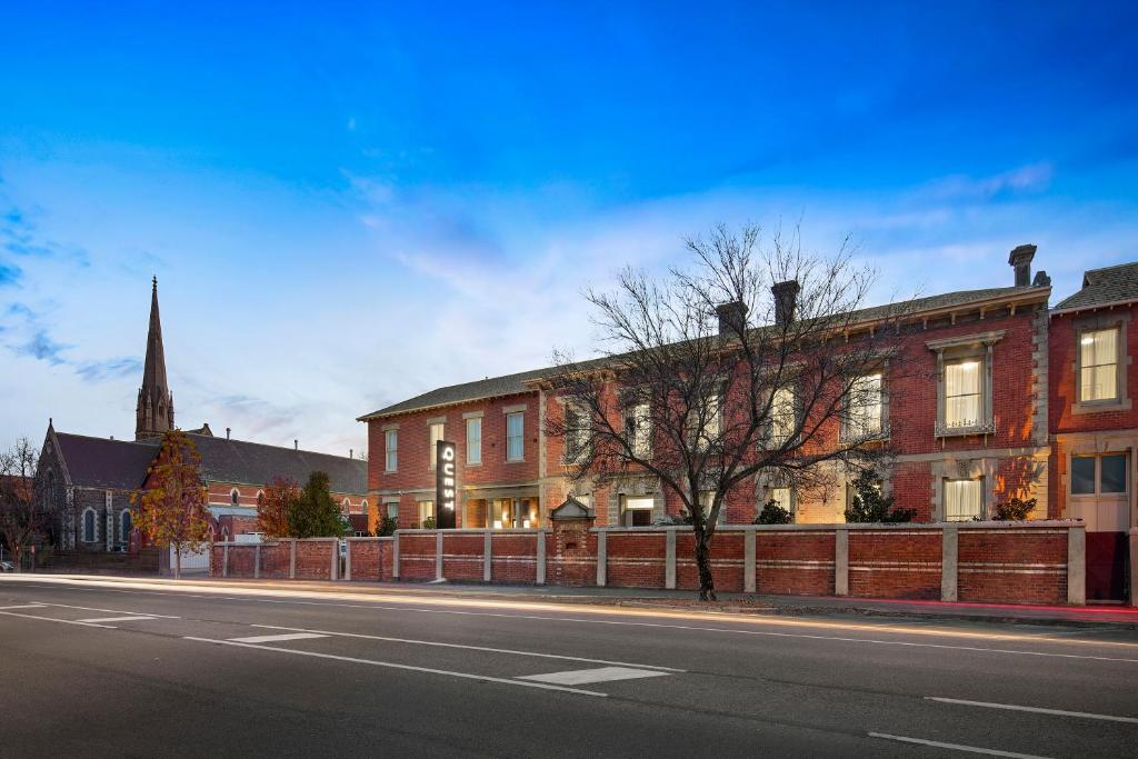 a large brick building with a clock on the side of it at Quest Ballarat in Ballarat