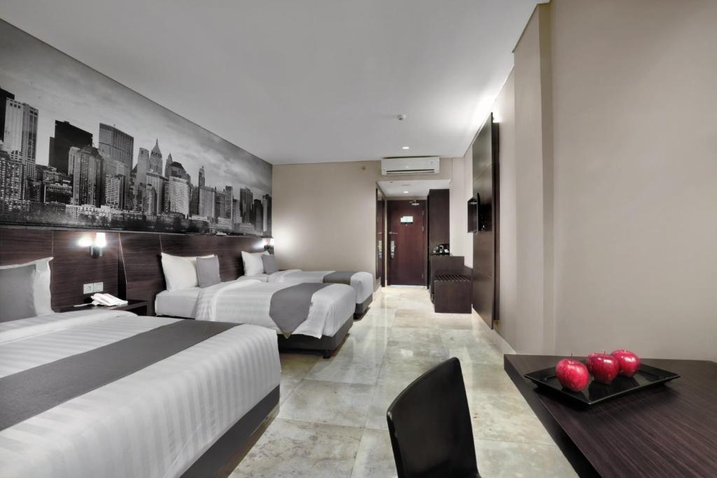 Postel nebo postele na pokoji v ubytování Hotel Neo+ Balikpapan by ASTON