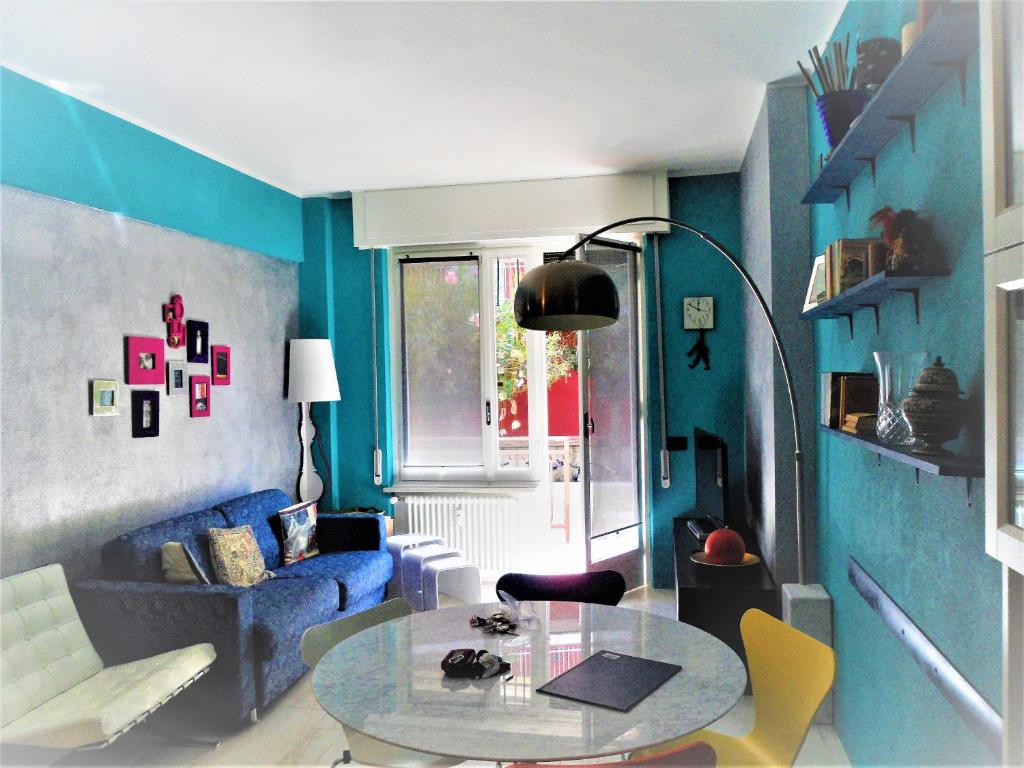 a blue living room with a table and a couch at 4effe Home in Sestri Levante