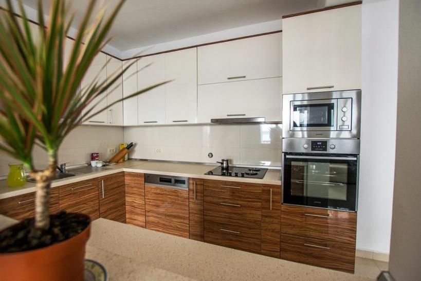 a kitchen with white cabinets and a potted plant at Apartment Andjela in Starigrad