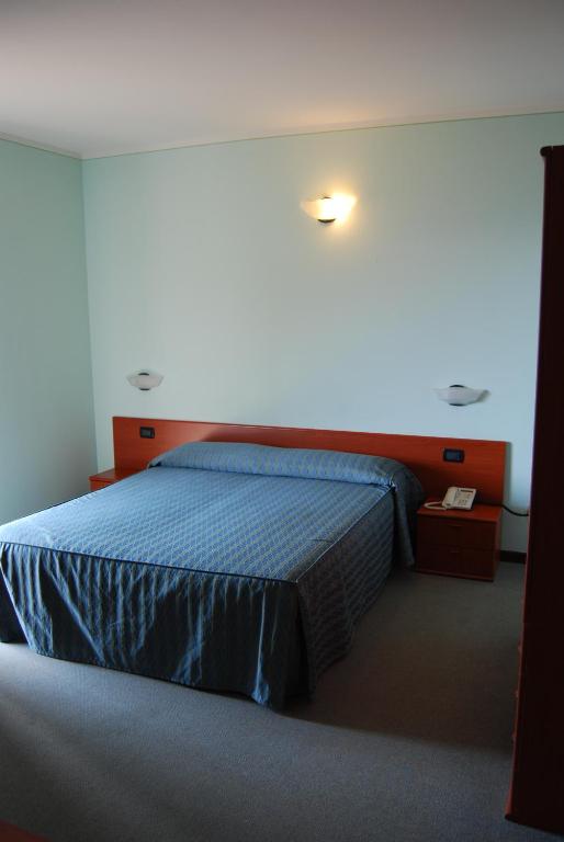 Postel nebo postele na pokoji v ubytování Albergo Ristorante Orazio