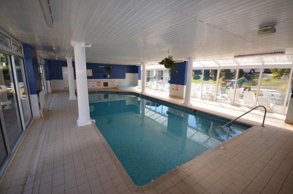 a large swimming pool in a building with a swimming pool at Laguna Hotel in Bournemouth