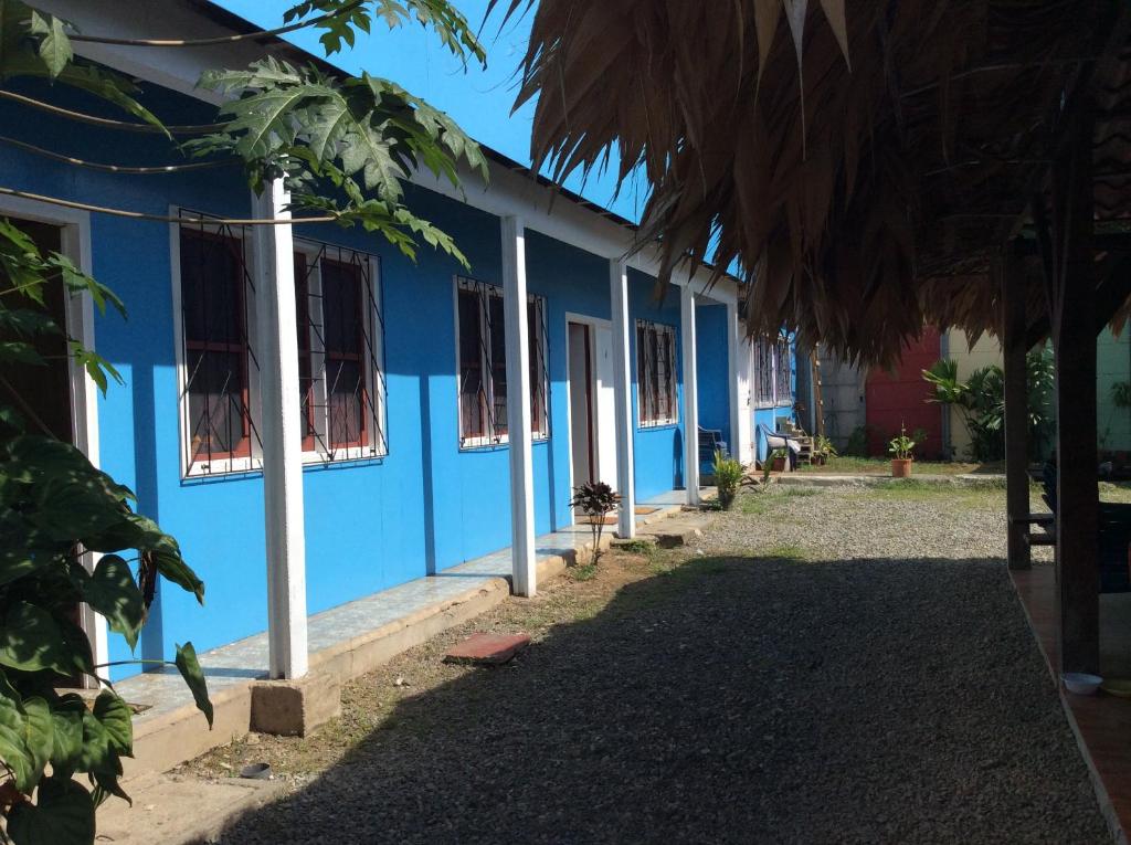 a blue building with windows on the side at Hotel One Love Puerto Viejo in Puerto Viejo
