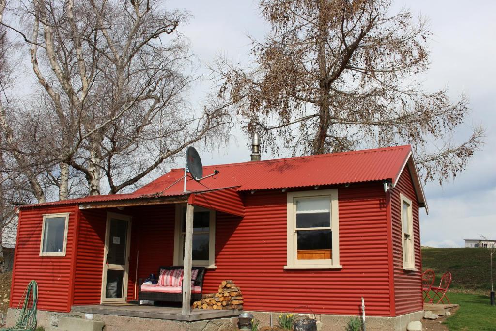 a red tiny house with a red roof at The Red Hut in Lake Tekapo