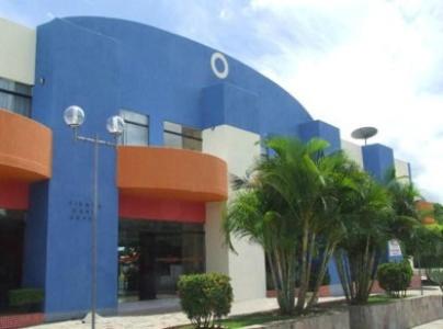 un edificio azul con palmeras delante en Fiesta Park Hotel, en Jacobina