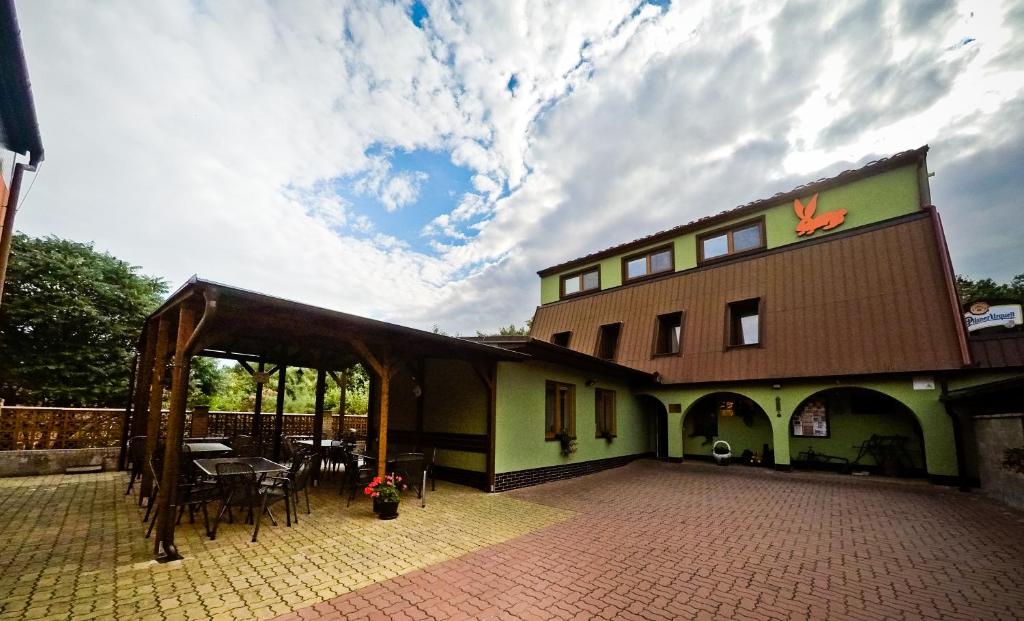 a building with a patio with a table and chairs at Penzion U Králíků in Kurdějov