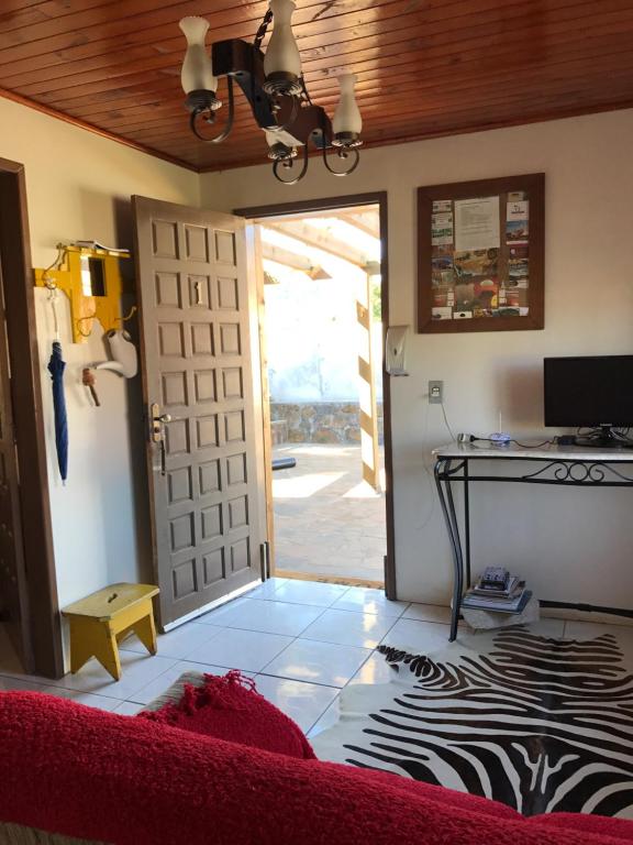 a living room with a door and a zebra floor at Chalés Energias da Serra in Bom Jardim da Serra