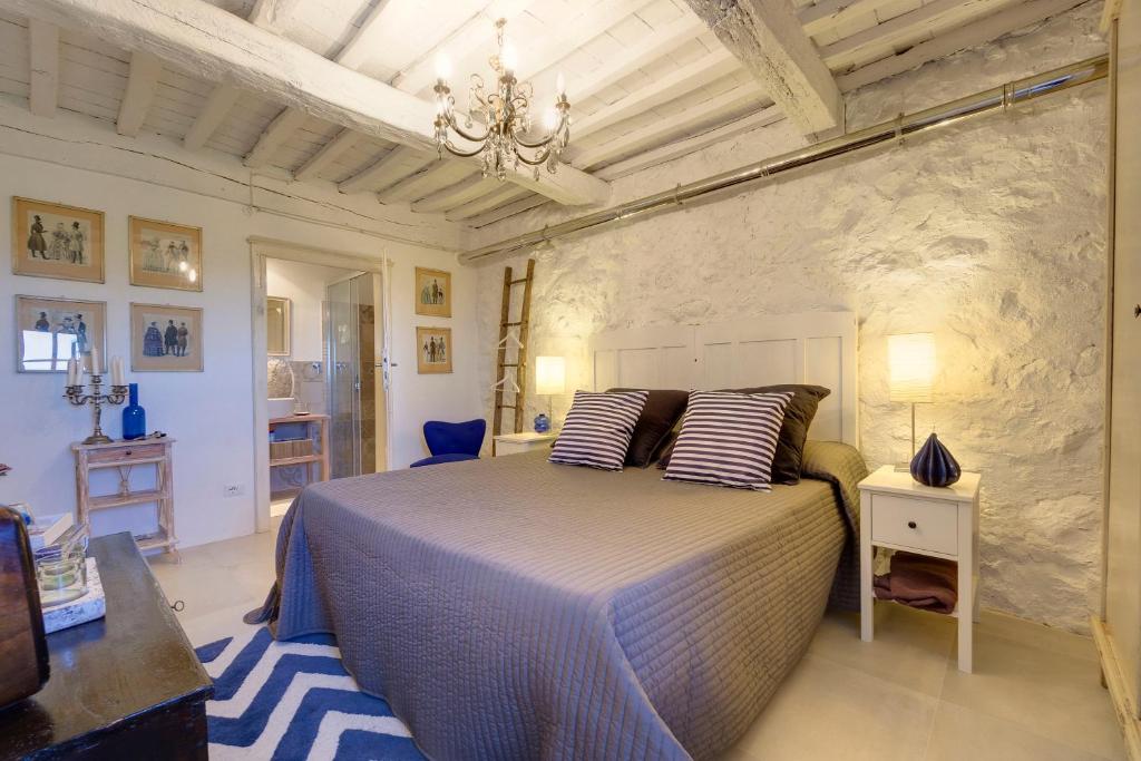 a bedroom with a large bed in a room at THE RETREAT a romantic bedroom in Maremma in Cana