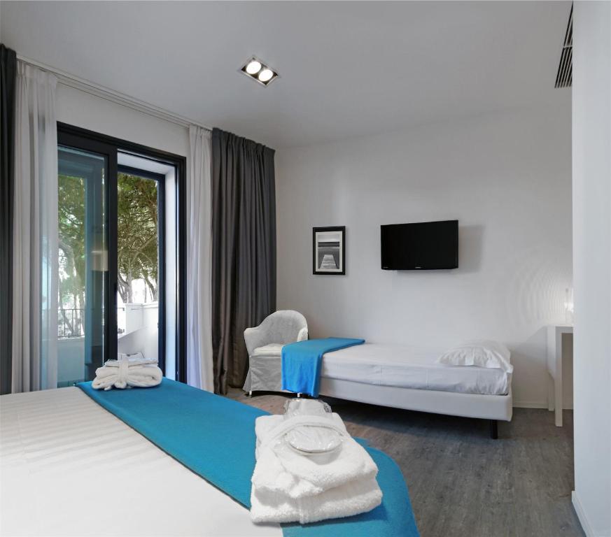 Postel nebo postele na pokoji v ubytování Hotel Europa Monetti