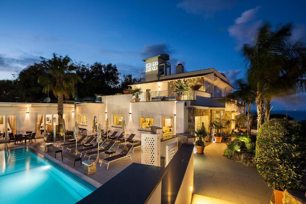 a house with a swimming pool in front of it at Grifo Hotel Charme & SPA in Ischia