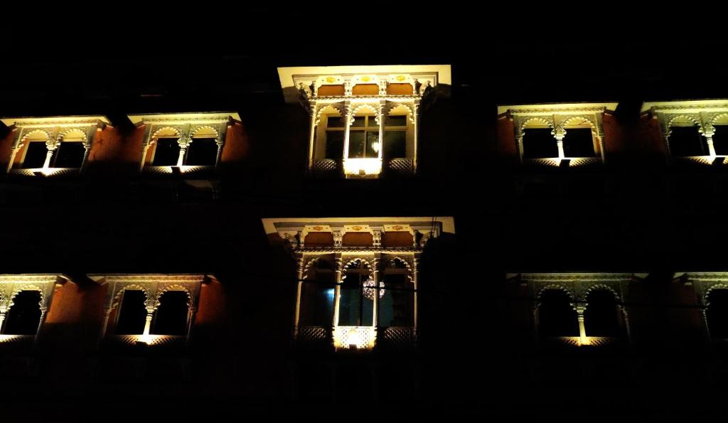 a night view of a building with lights at Hotel Parvati Palace Sehore in Sehore