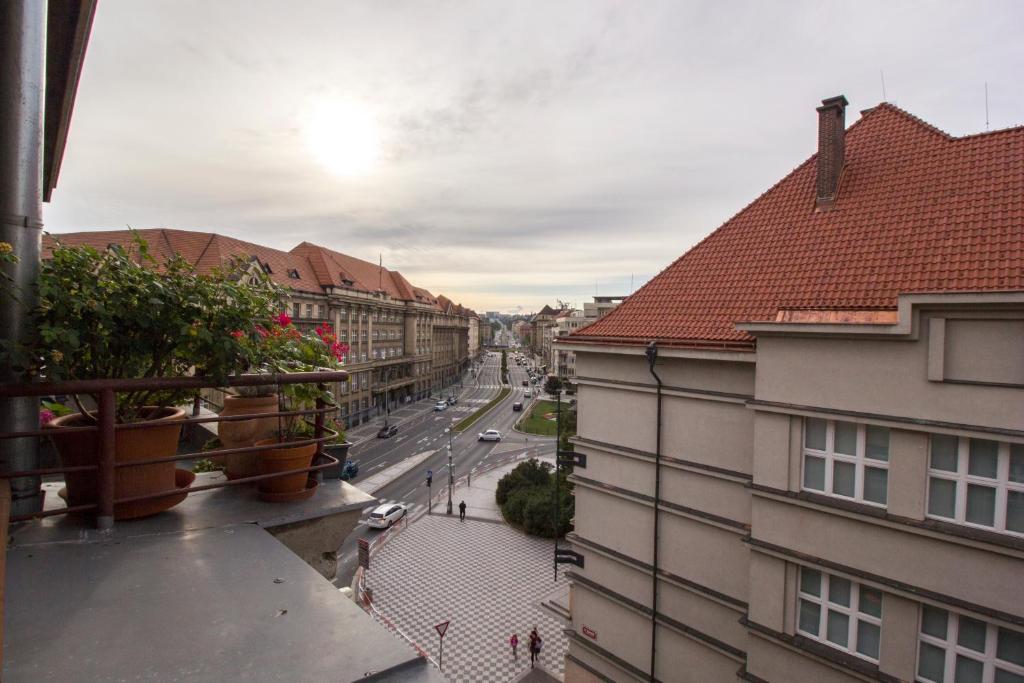 a view of a city street from a balcony at Apartmán Bubeneč in Prague