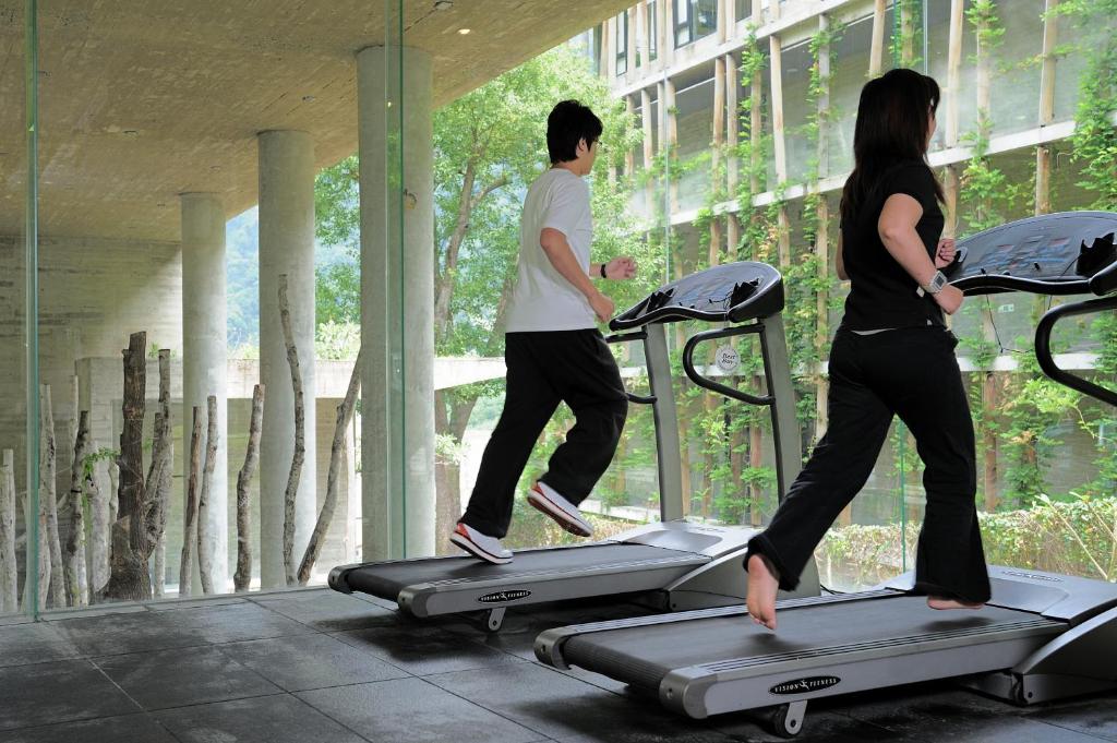 a man and a woman running on a treadmill at Onsen Papawaqa in Tai&#39;an