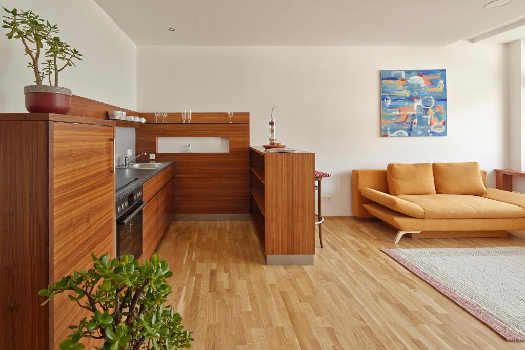 a living room with a couch and a kitchen at Apartment Markt Ardagger in Ardagger Markt