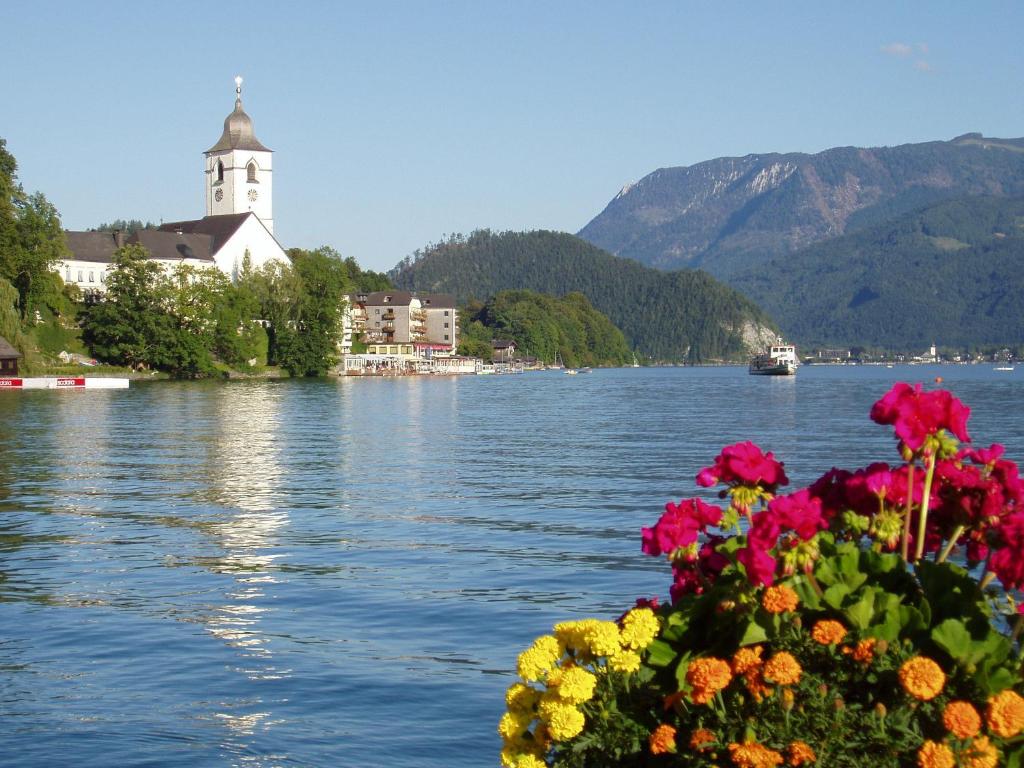 a bouquet of flowers on a boat on a lake at Schafberg Apartments in St. Wolfgang