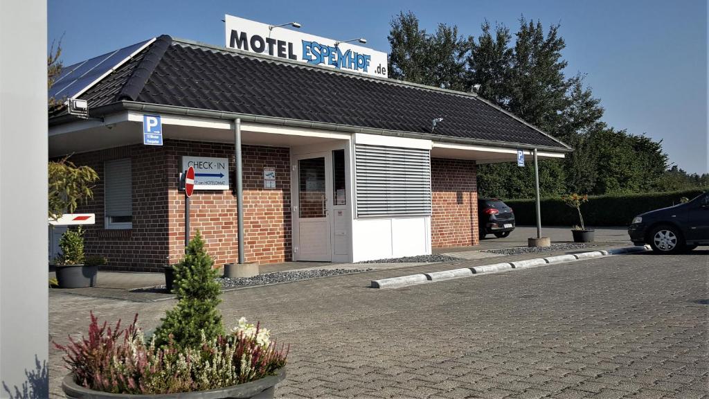 LadbergenにあるMotel Espenhofの煉瓦造りの建物の上のモーテルサイン