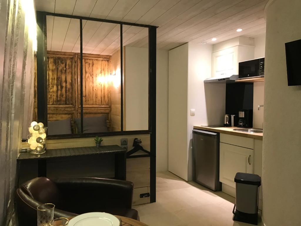 - une petite cuisine avec une table et un comptoir dans l'établissement Le lingotin, à Honfleur