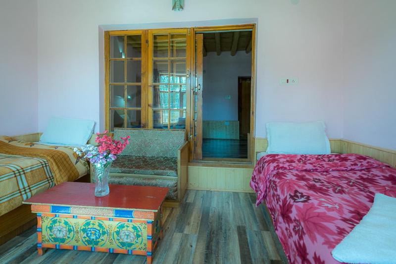 Rúm í herbergi á Siala Guest House