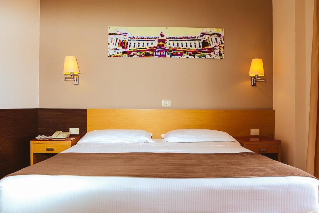 Postel nebo postele na pokoji v ubytování Hotel Sisto V