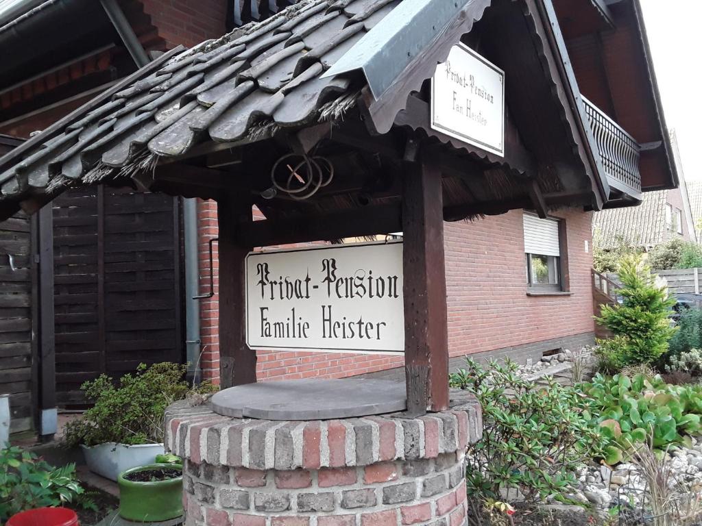 a sign in front of a brick building at Pension Heister in Isselburg