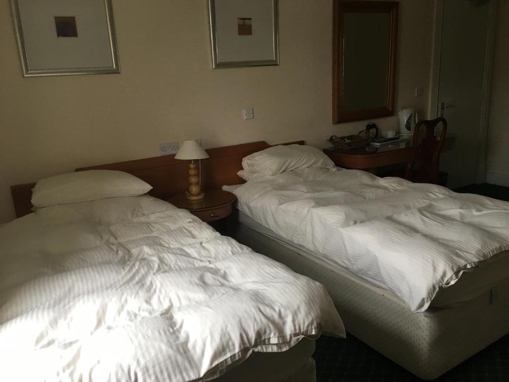 two beds sitting next to each other in a room at The Bridge View in Runcorn