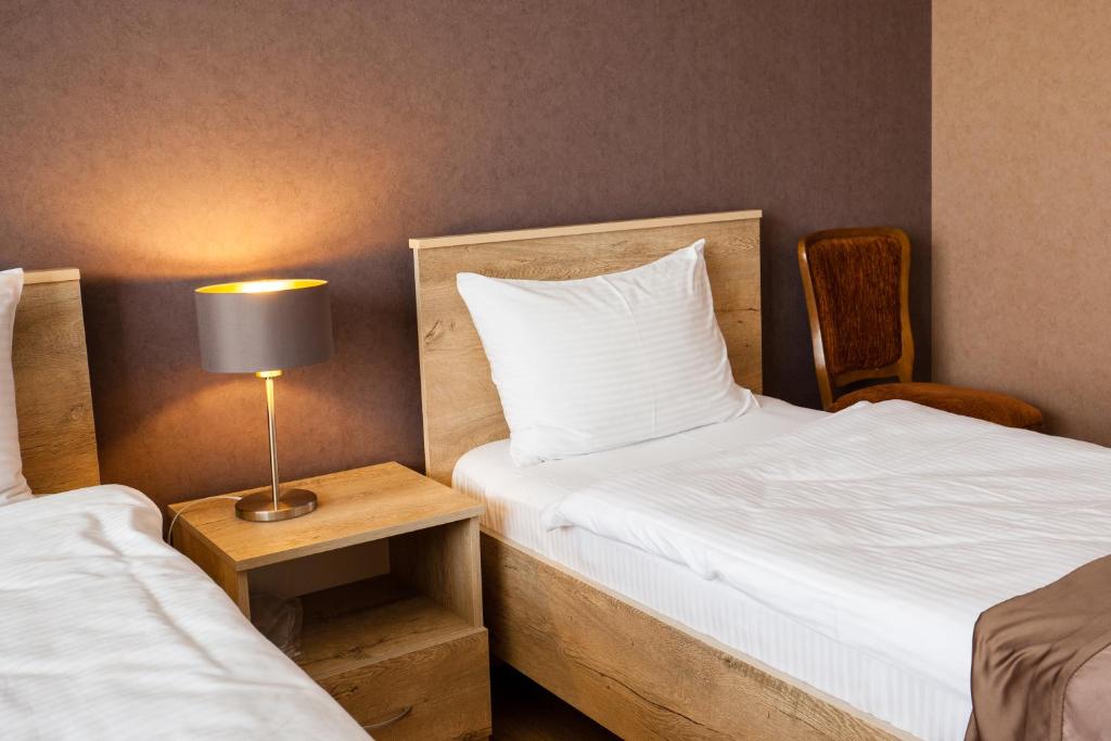 Voodi või voodid majutusasutuse Hotel Almi toas