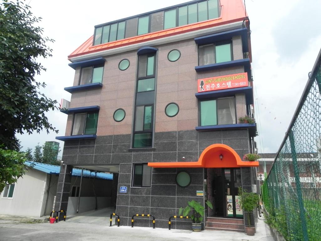 a tall building with a sign on it at Jeonju International Hostel in Jeonju