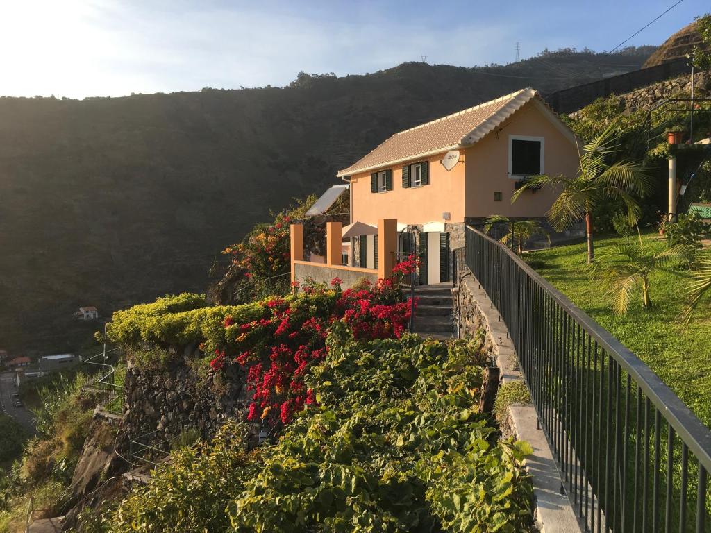 a house on a hill with flowers at Quinta Terezinha in Ribeira Brava
