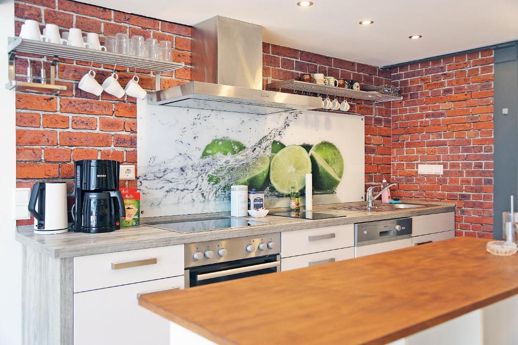 a kitchen with a brick wall at Loft-Unterkunft in Sinsheim