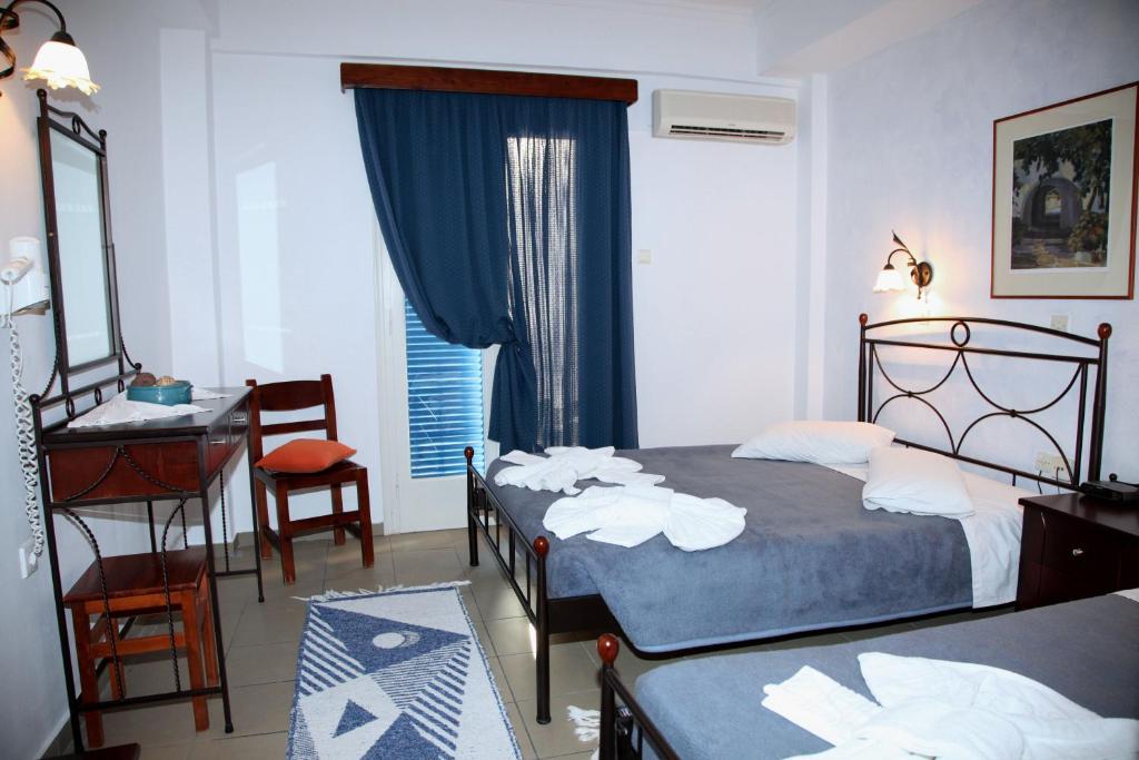 Postel nebo postele na pokoji v ubytování Nikolas Hotel
