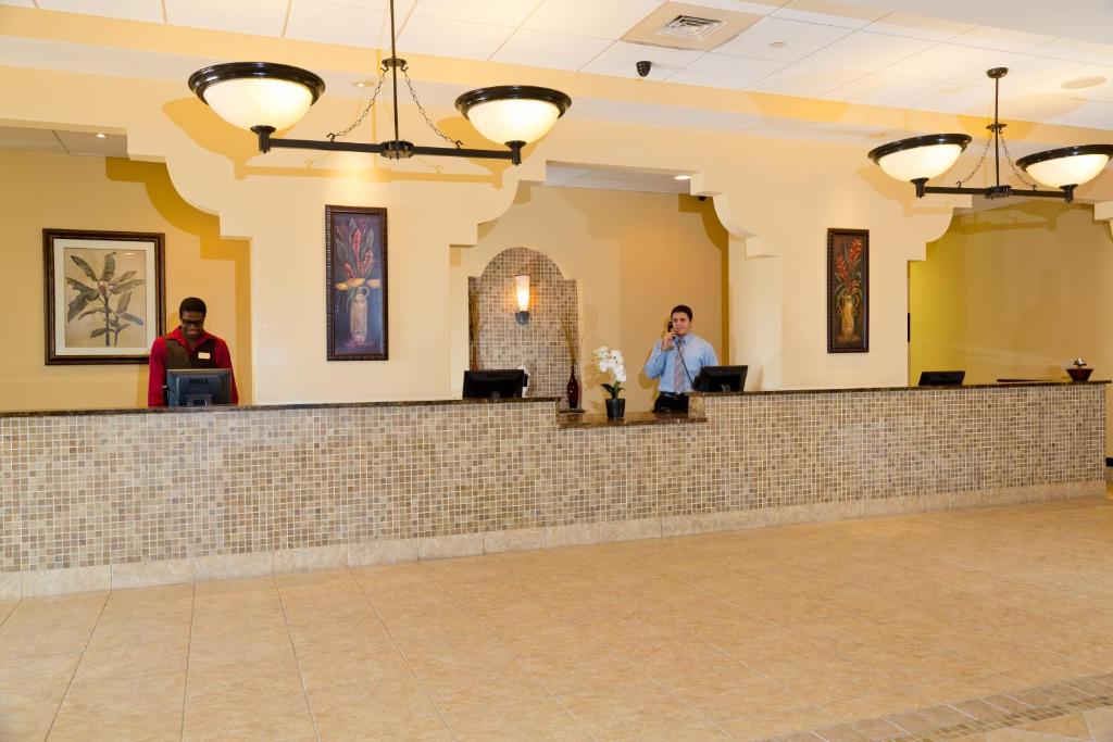 a woman standing at a bar in a lobby at Lake Buena Vista Resort Village and Spa, Near Disney in Orlando